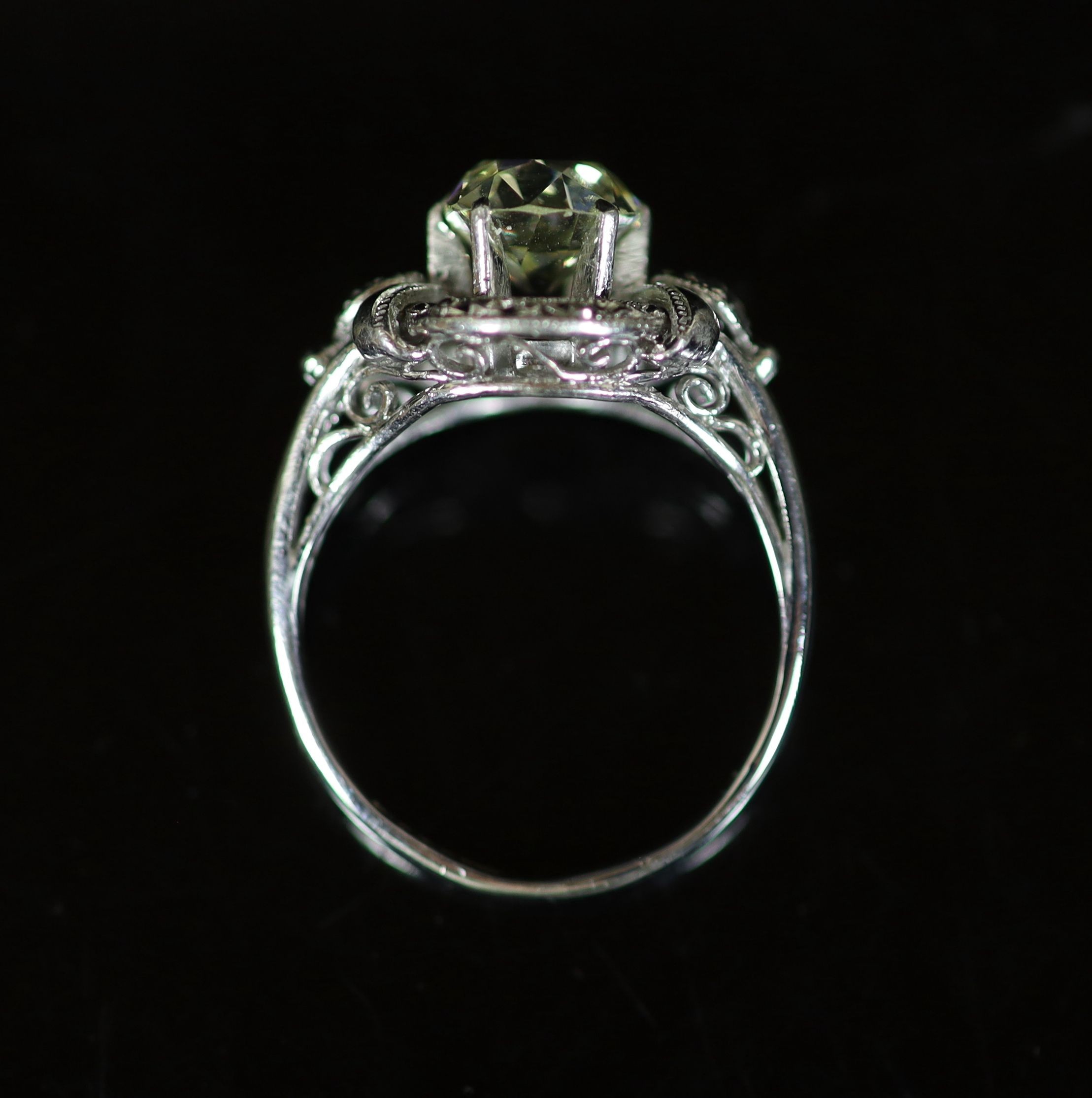 A white gold and oval cut solitaire diamond ring, in a raised claw setting